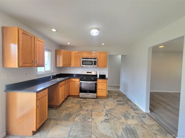 11618 Highland Dr, Warren, MI 48089 - kitchen featuring appliances with stainless steel finishes, a sink, dark countertops, baseboards, and recessed lighting