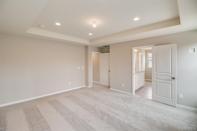 3660 Hayes Ct, Ypsilanti, MI 48197 - unfurnished bedroom with a tray ceiling, light colored carpet, recessed lighting, and baseboards