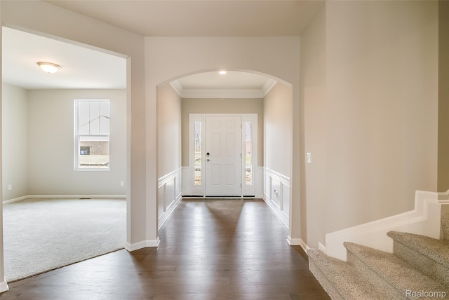 3660 Hayes Ct, Ypsilanti, MI 48197 - entrance foyer with arched walkways, ornamental molding, dark wood-style flooring, wainscoting, and stairway