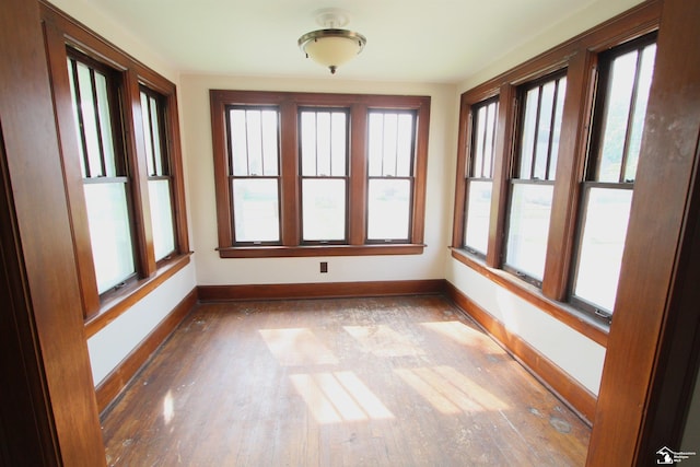624 Waterloo Ave, Monroe, MI 48161 - unfurnished sunroom featuring baseboards, plenty of natural light, and hardwood / wood-style floors