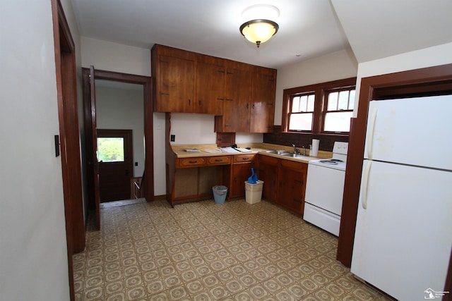 624 Waterloo Ave, Monroe, MI 48161 - kitchen featuring white appliances, light countertops, light floors, and brown cabinets