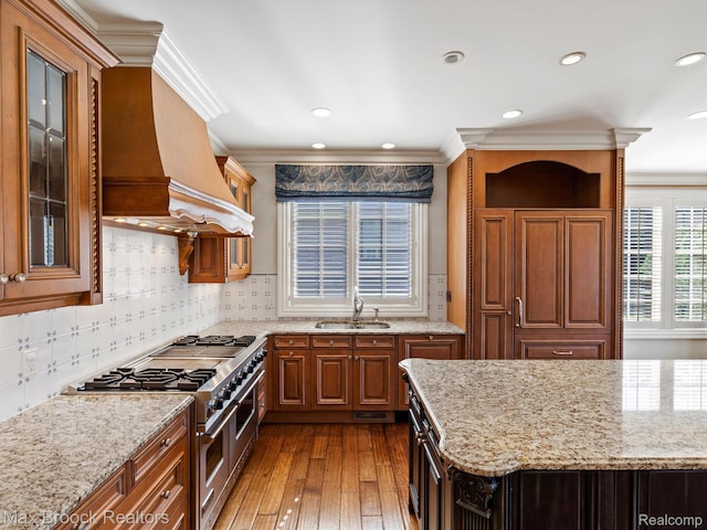 2921 Turtle Pond Ct, Bloomfield Hills, MI 48302 - kitchen featuring double oven range, a sink, light stone counters, dark wood-type flooring, and crown molding