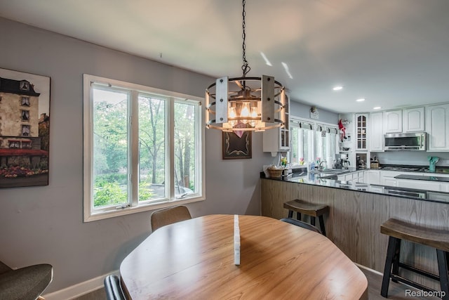 2475 S Ortonville Rd S, Ortonville, MI 48462 - dining space featuring healthy amount of natural light, a chandelier, recessed lighting, and baseboards