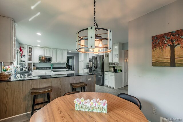 2475 S Ortonville Rd S, Ortonville, MI 48462 - dining area with a chandelier, wood finished floors, and recessed lighting