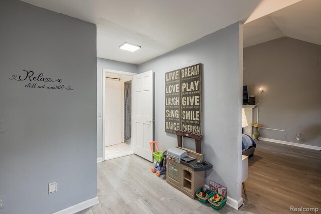 2475 S Ortonville Rd S, Ortonville, MI 48462 - hall featuring wood finished floors, baseboards, and lofted ceiling