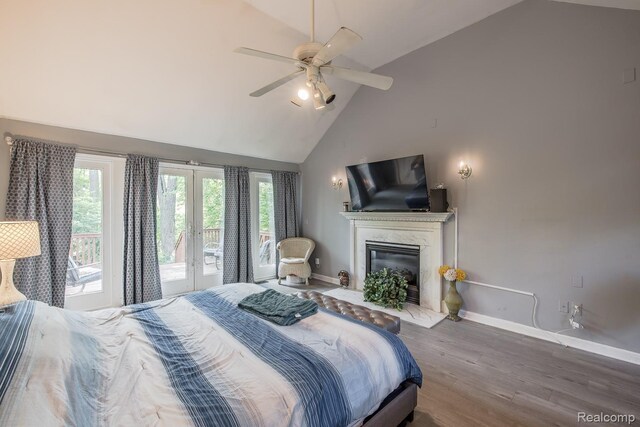 2475 S Ortonville Rd S, Ortonville, MI 48462 - bedroom with baseboards, wood finished floors, high vaulted ceiling, access to exterior, and a high end fireplace