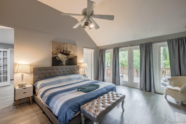 2475 S Ortonville Rd S, Ortonville, MI 48462 - bedroom with french doors, access to exterior, multiple windows, wood finished floors, and lofted ceiling