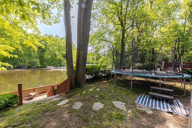 2475 S Ortonville Rd S, Ortonville, MI 48462 - view of yard featuring a trampoline, a water view, and a forest view