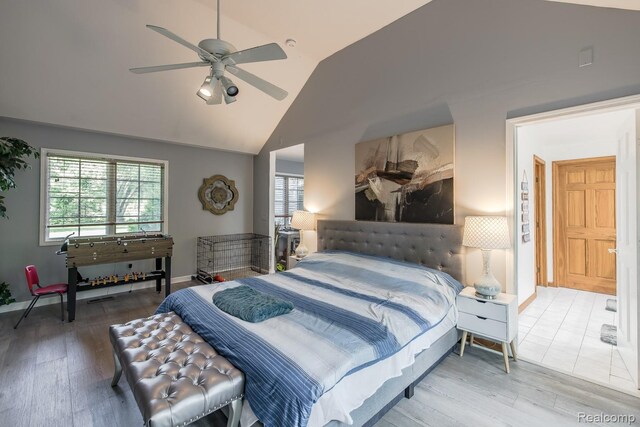 2475 S Ortonville Rd S, Ortonville, MI 48462 - bedroom featuring wood finished floors, vaulted ceiling, baseboards, and ceiling fan