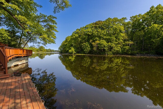 2475 S Ortonville Rd S, Ortonville, MI 48462 - dock with a water view and a wooded view
