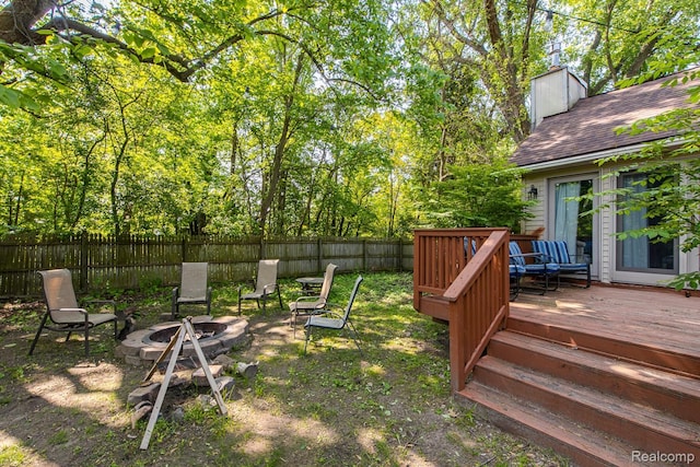 2475 S Ortonville Rd S, Ortonville, MI 48462 - fenced backyard featuring an outdoor fire pit and a wooden deck