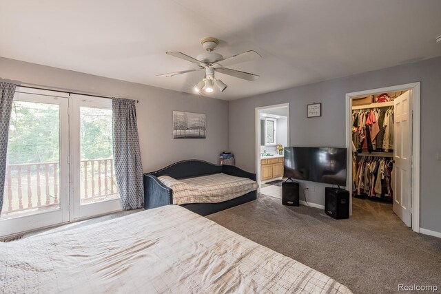 2475 S Ortonville Rd S, Ortonville, MI 48462 - bedroom with access to outside, a walk in closet, carpet flooring, baseboards, and ensuite bath