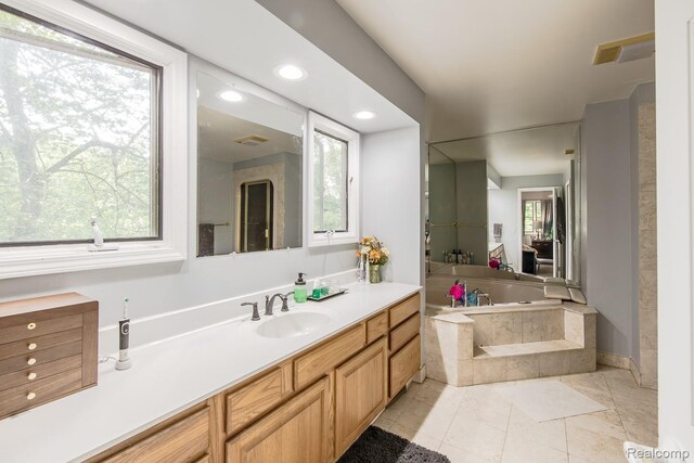 2475 S Ortonville Rd S, Ortonville, MI 48462 - bathroom featuring a bath, vanity, and recessed lighting