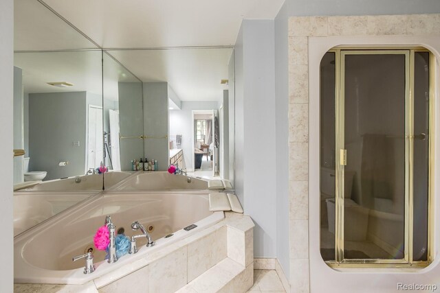 2475 S Ortonville Rd S, Ortonville, MI 48462 - bathroom with a whirlpool tub, toilet, a stall shower, tile patterned flooring, and baseboards