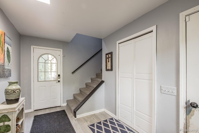 2475 S Ortonville Rd S, Ortonville, MI 48462 - entryway featuring stairway, light wood finished floors, and baseboards