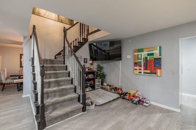 2475 S Ortonville Rd S, Ortonville, MI 48462 - staircase featuring wood finished floors and baseboards