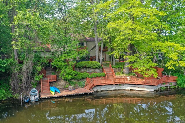 2475 S Ortonville Rd S, Ortonville, MI 48462 - back of property featuring stairway and a deck with water view