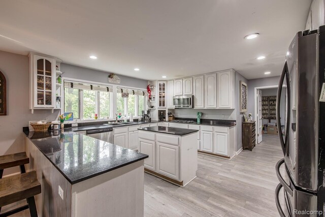 2475 S Ortonville Rd S, Ortonville, MI 48462 - kitchen featuring stainless steel appliances, a peninsula, recessed lighting, and white cabinetry