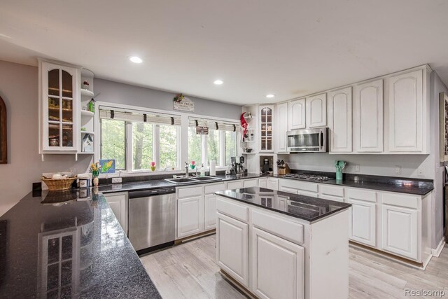 2475 S Ortonville Rd S, Ortonville, MI 48462 - kitchen featuring appliances with stainless steel finishes, open shelves, a sink, glass insert cabinets, and recessed lighting