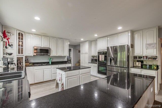 2475 S Ortonville Rd S, Ortonville, MI 48462 - kitchen featuring stainless steel appliances, recessed lighting, white cabinetry, a sink, and a kitchen island