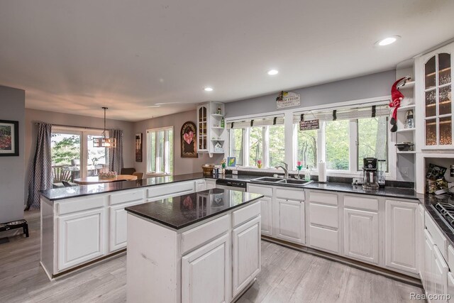 2475 S Ortonville Rd S, Ortonville, MI 48462 - kitchen with open shelves, a sink, a peninsula, white cabinetry, and recessed lighting
