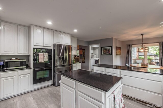 2475 S Ortonville Rd S, Ortonville, MI 48462 - kitchen with appliances with stainless steel finishes, a kitchen island, white cabinetry, light wood-style floors, and recessed lighting