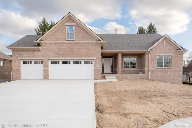 3201 Roma Ct, Wixom, MI 48393 - view of front of home with brick siding, driveway, roof with shingles, and a garage