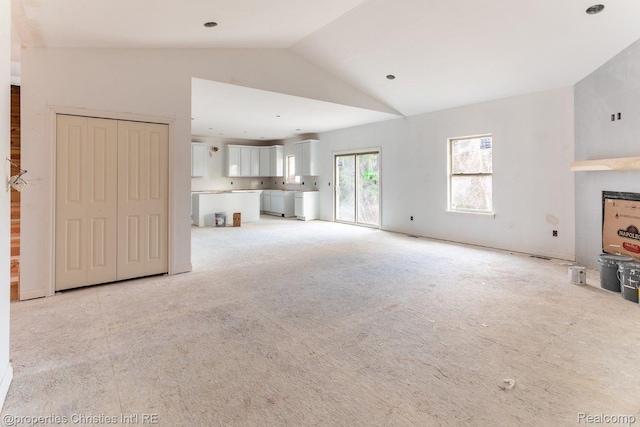 3201 Roma Ct, Wixom, MI 48393 - unfurnished living room with vaulted ceiling and light colored carpet