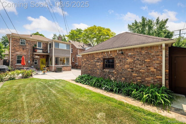 20171 Renfrew Rd, Detroit, MI 48221 - back of house featuring a patio area, brick siding, and a lawn