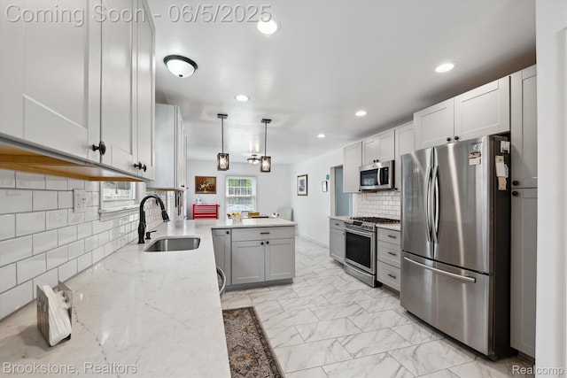 20171 Renfrew Rd, Detroit, MI 48221 - kitchen with stainless steel appliances, a sink, a peninsula, recessed lighting, and light stone counters