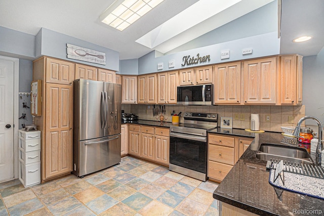 7374 Cross Creek Dr, Swartz Creek, MI 48473 - kitchen featuring stainless steel appliances, a sink, decorative backsplash, dark stone countertops, and light brown cabinetry