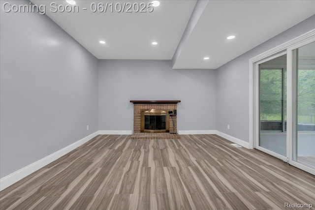 2148 E Roundtable Dr, Canton, MI 48188 - unfurnished living room with wood finished floors, baseboards, a brick fireplace, and recessed lighting