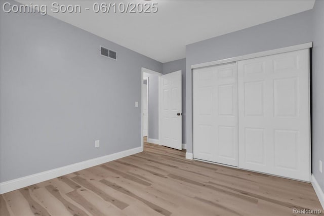 2148 E Roundtable Dr, Canton, MI 48188 - unfurnished bedroom with wood finished floors, baseboards, and a closet