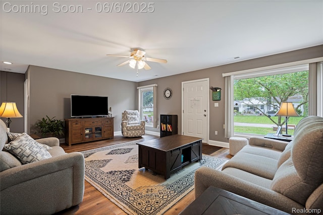 3886 Queensbury Rd, Lake Orion, MI 48359 - living area with wood finished floors, ceiling fan, and baseboards