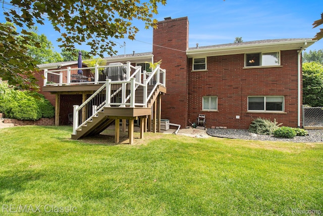 38 Meadowview Dr, Howell, MI 48843 - rear view of house with a chimney, stairway, a wooden deck, a lawn, and brick siding