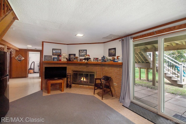 38 Meadowview Dr, Howell, MI 48843 - living area featuring healthy amount of natural light, a textured ceiling, a fireplace, and tile patterned floors
