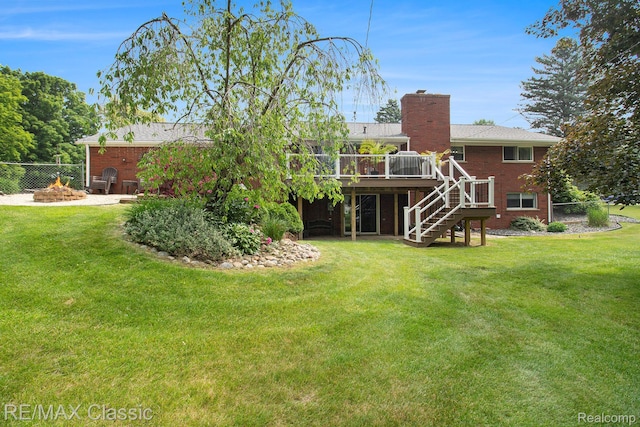 38 Meadowview Dr, Howell, MI 48843 - rear view of property featuring stairway, an outdoor fire pit, a deck, a chimney, and brick siding