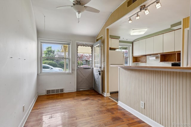 3417 Edgewood Dr, Ann Arbor, MI 48104 - kitchen with freestanding refrigerator, healthy amount of natural light, hardwood / wood-style flooring, and white cabinetry