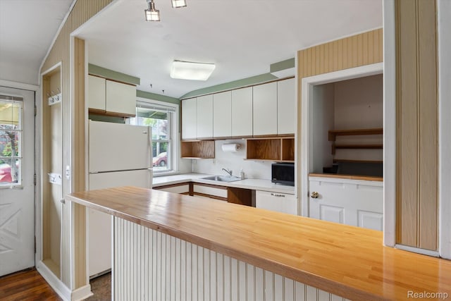 3417 Edgewood Dr, Ann Arbor, MI 48104 - kitchen featuring freestanding refrigerator, black microwave, a sink, white cabinetry, and butcher block countertops