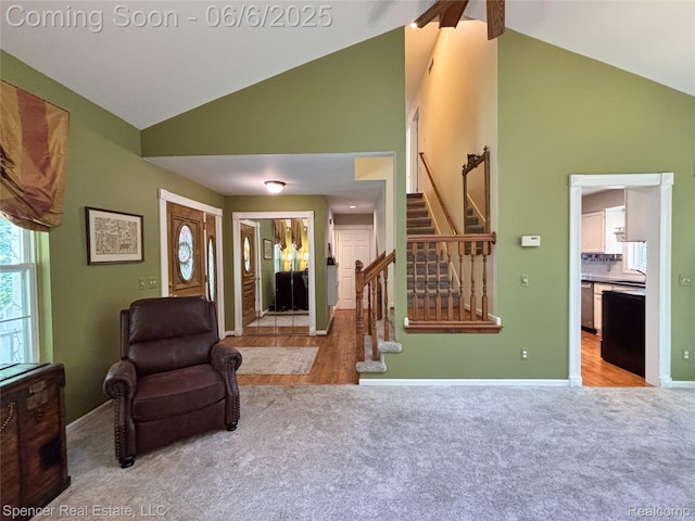 5005 Mohawk Ave, Clarkston, MI 48348 - carpeted living room with high vaulted ceiling, stairs, baseboards, and a sink