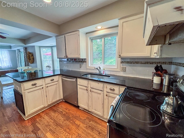 5005 Mohawk Ave, Clarkston, MI 48348 - kitchen featuring stainless steel dishwasher, electric range, a peninsula, dark countertops, and a sink