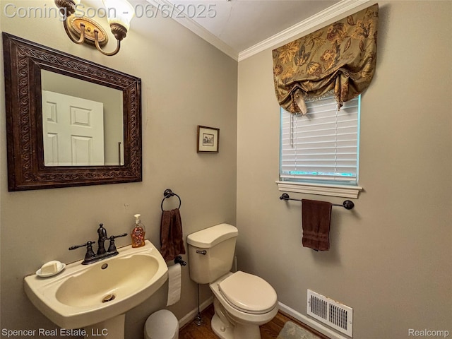 5005 Mohawk Ave, Clarkston, MI 48348 - bathroom with crown molding, toilet, a sink, baseboards, and wood finished floors