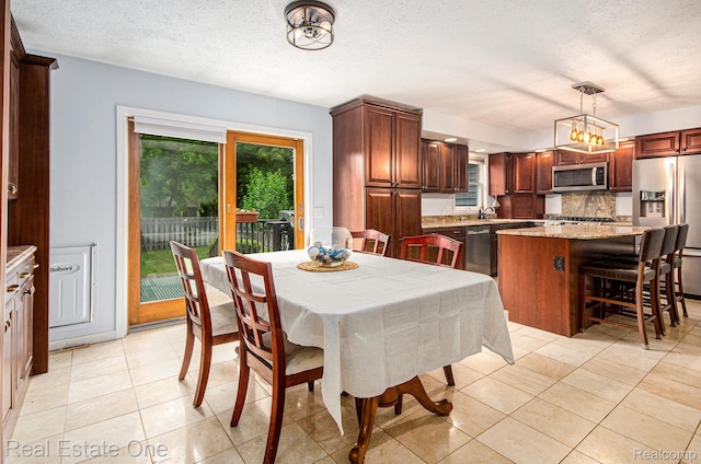 2400 Rolandale, West Bloomfield, MI 48324 - dining area with light tile patterned floors, a textured ceiling, and a chandelier