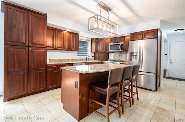 2400 Rolandale, West Bloomfield, MI 48324 - kitchen with appliances with stainless steel finishes, light tile patterned floors, a center island, and a breakfast bar area