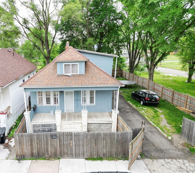 13714 Fenelon St, Detroit, MI 48212 - view of front of property featuring a shingled roof, a porch, a fenced front yard, and a chimney