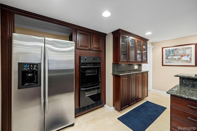 2401 Spyglass Dr, Oakland, MI 48363 - kitchen featuring stainless steel fridge, dark stone countertops, decorative backsplash, glass insert cabinets, and recessed lighting