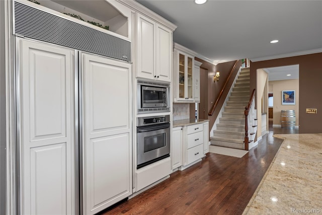 2401 Spyglass Dr, Oakland, MI 48363 - kitchen with built in appliances, glass insert cabinets, light stone countertops, white cabinets, and crown molding