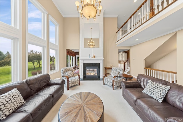 2401 Spyglass Dr, Oakland, MI 48363 - carpeted living area featuring a chandelier, a high ceiling, stairs, crown molding, and a high end fireplace
