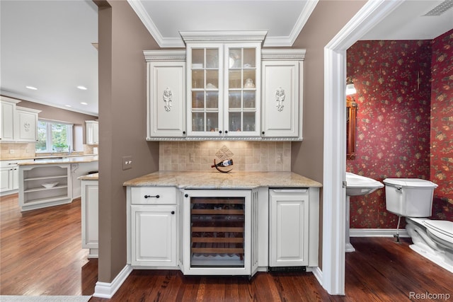 2401 Spyglass Dr, Oakland, MI 48363 - bar with beverage cooler, dark wood-style floors, wallpapered walls, tasteful backsplash, and ornamental molding