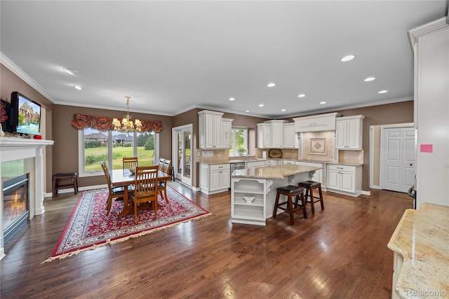 2401 Spyglass Dr, Oakland, MI 48363 - dining area featuring crown molding, healthy amount of natural light, a chandelier, dark wood-style flooring, and a fireplace
